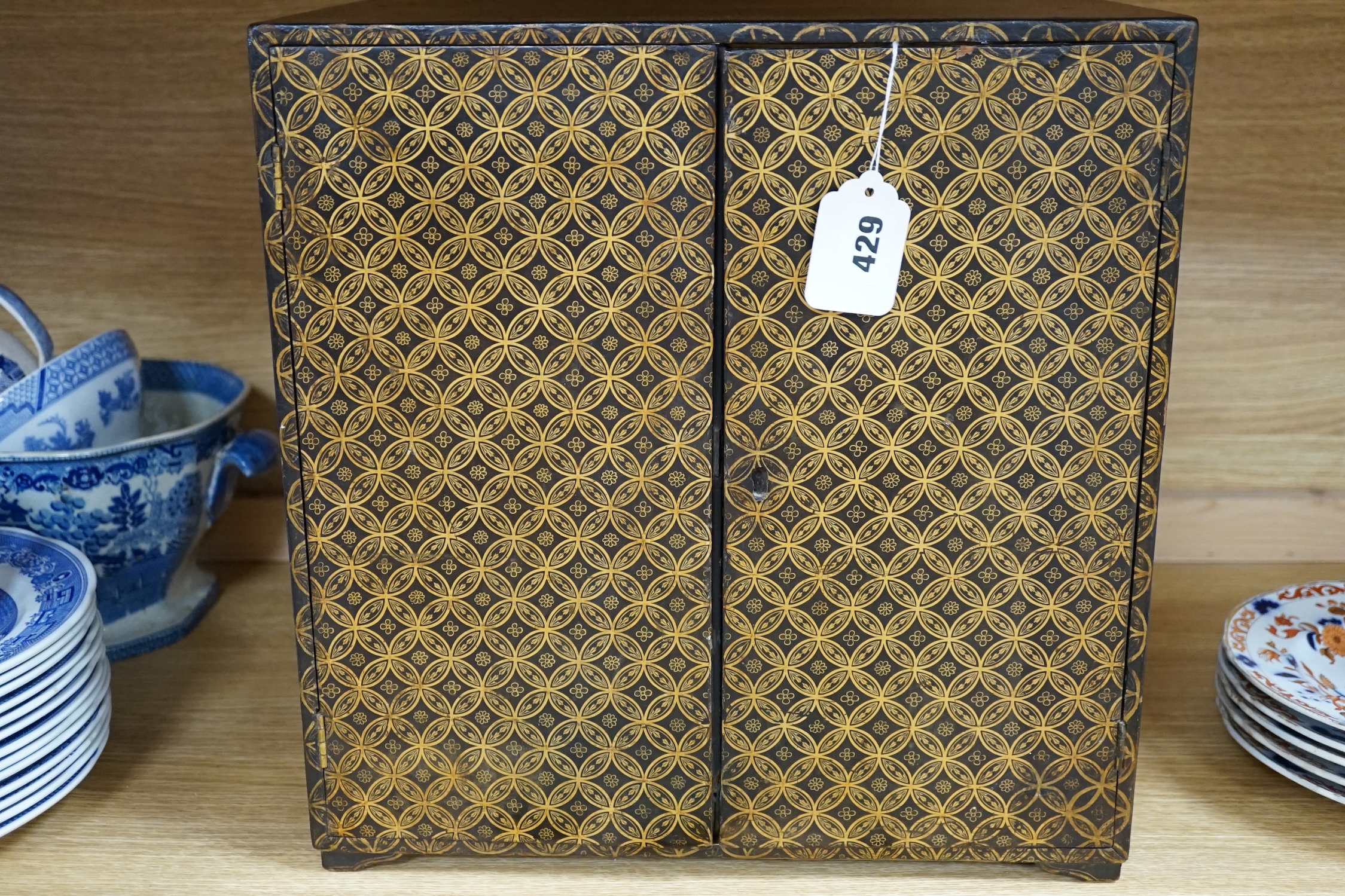 A 19th century Japanese gilt lacquered table cabinet, 38cm tall. Condition - fair